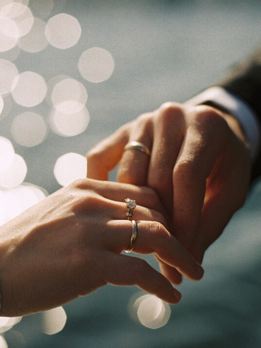 Hands of Husband and Wife with Their Wedding Rings